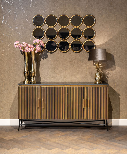 luxury buffet sideboard in front of a cavalli wallpaper.