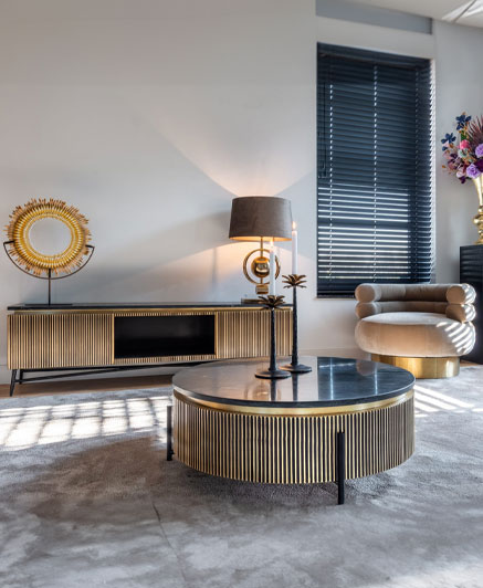 gold luxurious tv stand near the wall in a living room.