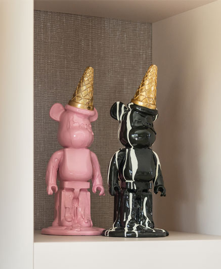 Deco object bear pink black with ice cream cone on head.