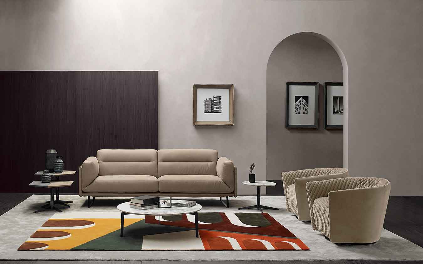 beige leather 2-seater sofa with silver legs, modern simple stylish sofa with matching armchairs with capitone look, marble circular coffee table, marmarino kentriko trapezaki,